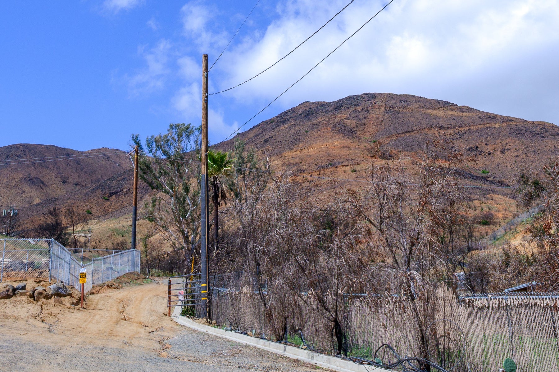 Hilly landscape after a wild fire has burned all the vegetation.