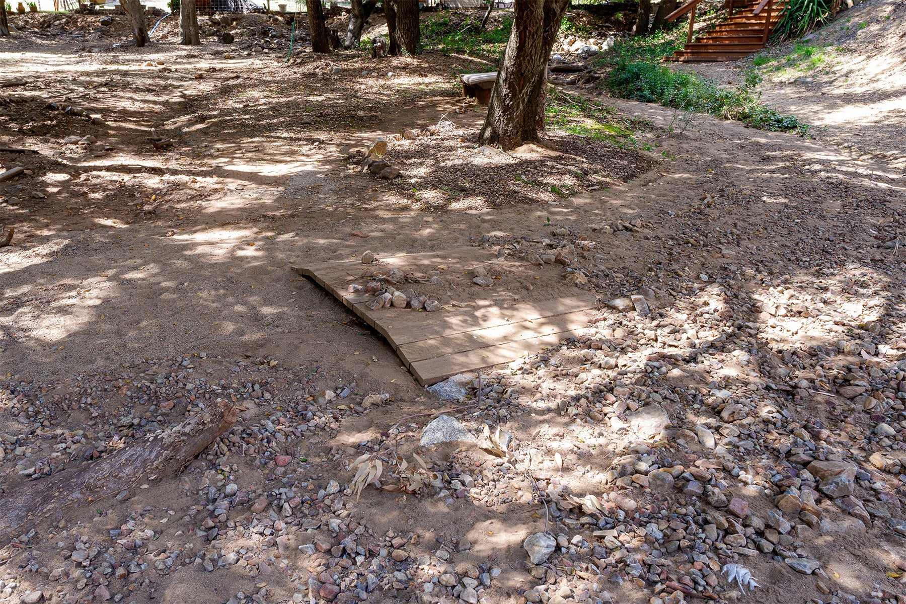 Buried wooden bridge in a wooded area