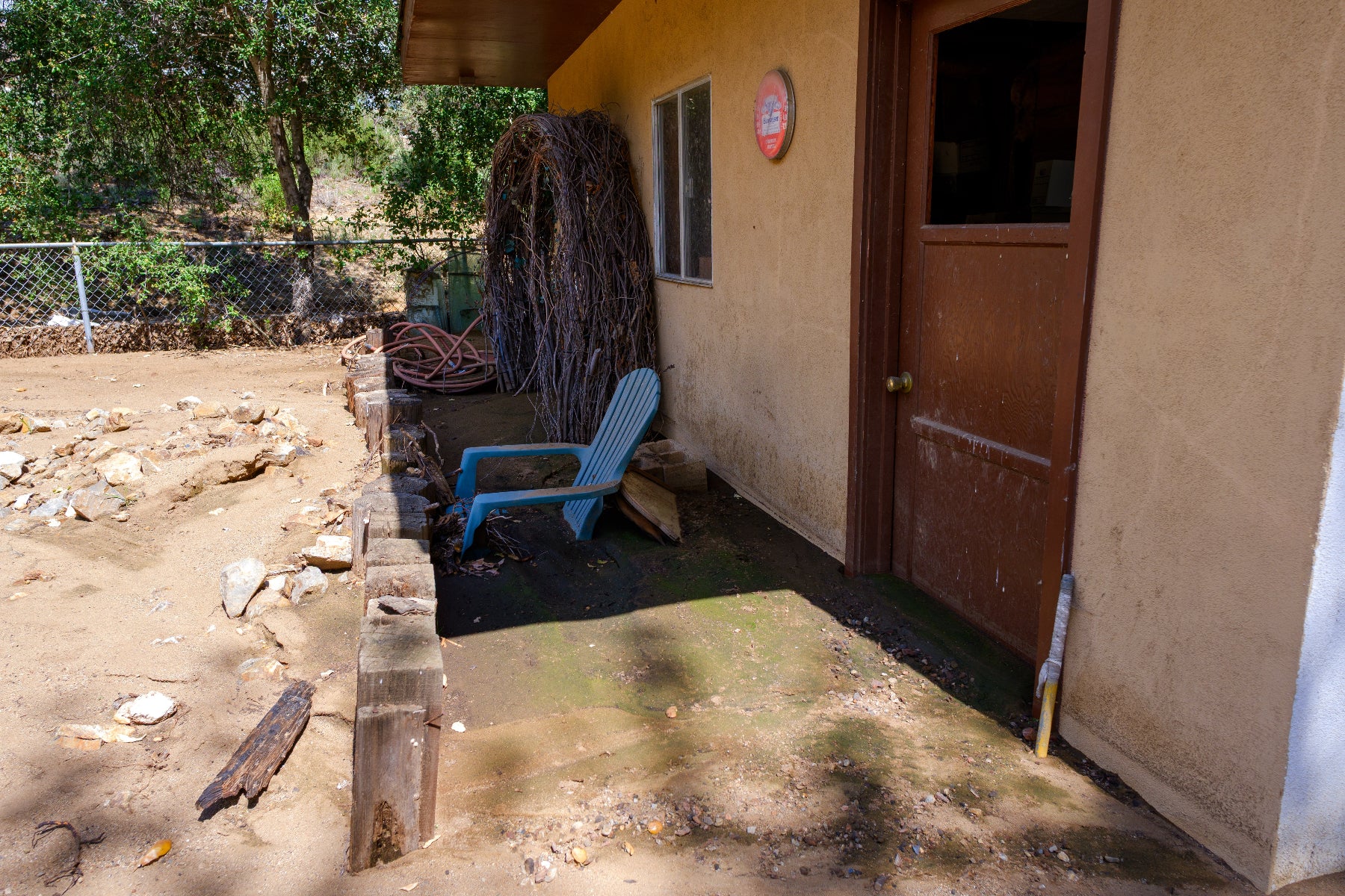 House exterior with mud burying the porch.