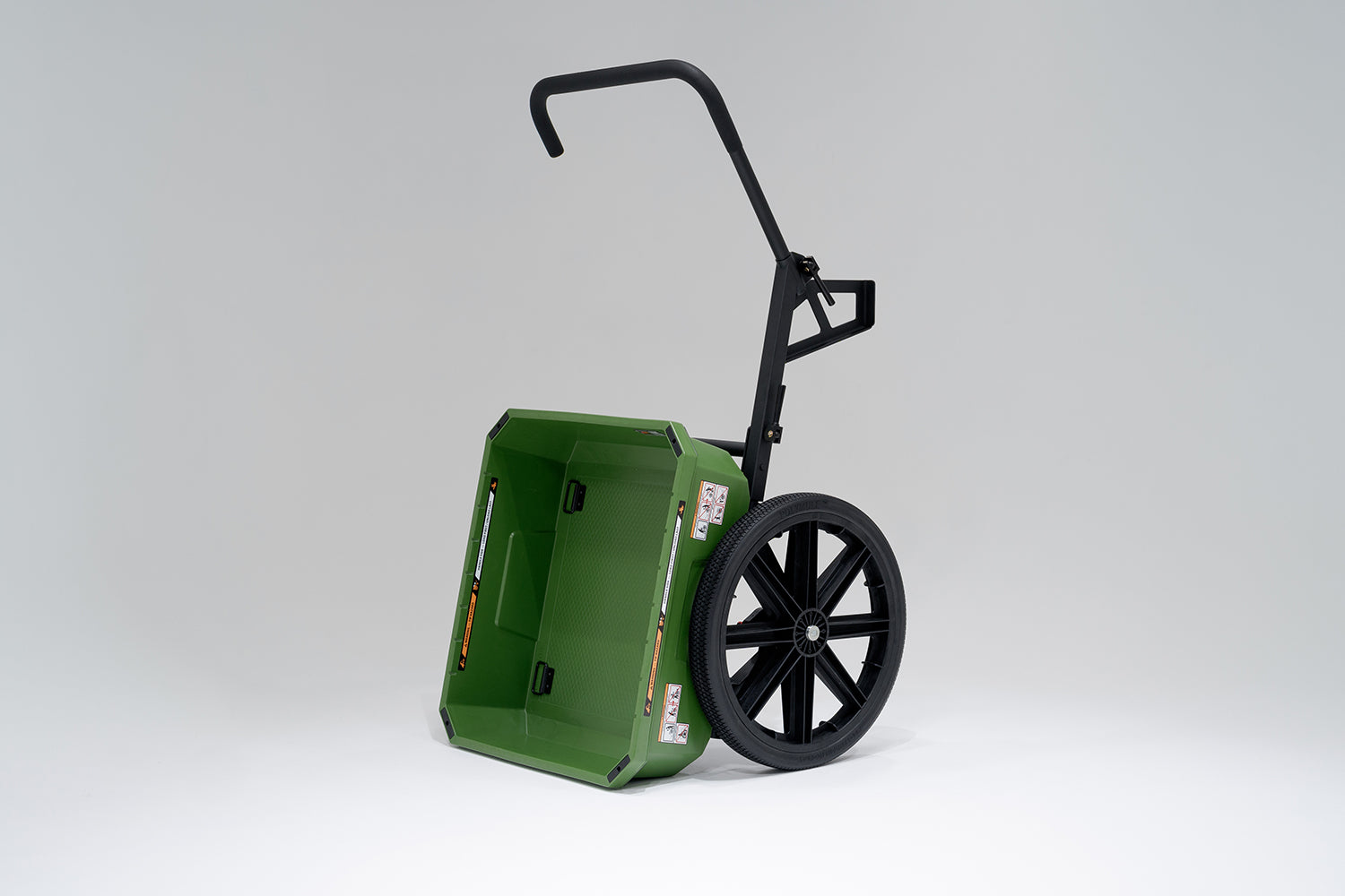 Green WARRIOR Utility Cart with black wheels and a forward handle. The cart is tipped for dumping.