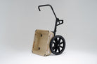 Tan WARRIOR Utility Cart with black wheels and a forward handle. The cart is tipped up for dumping.
