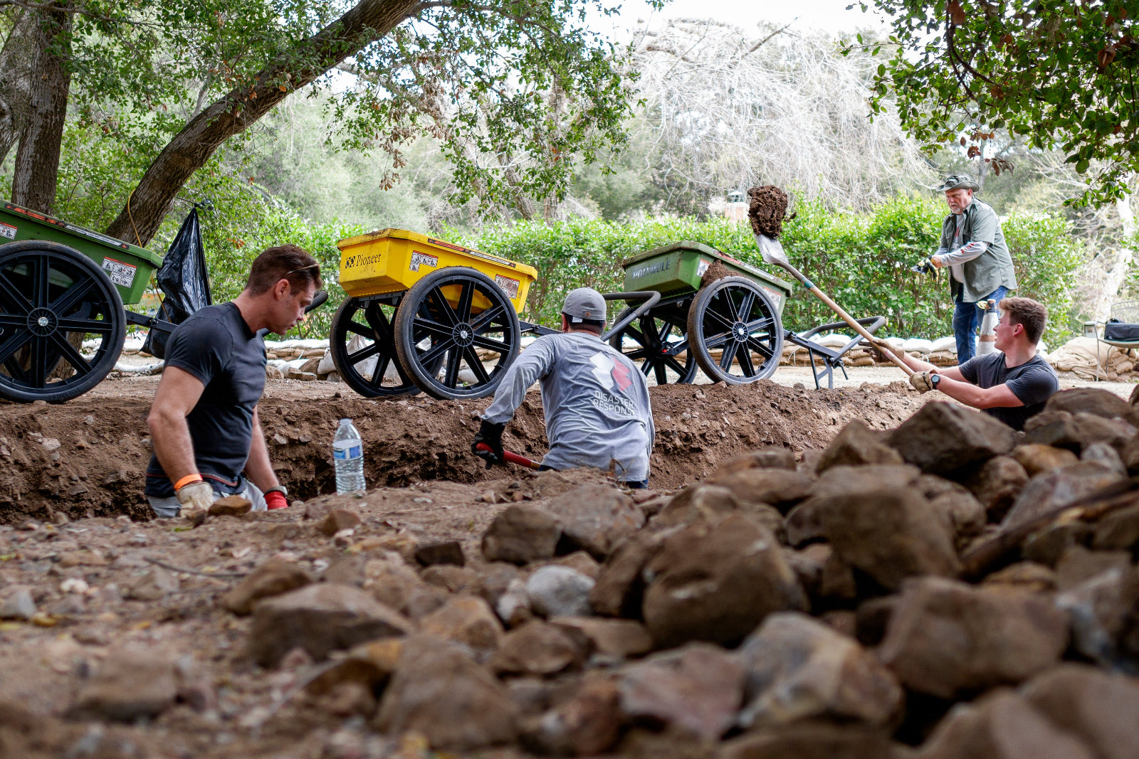 Volunteers from Team Rubicon and the LDS church help clear a waterway affected by the CA wildfires.